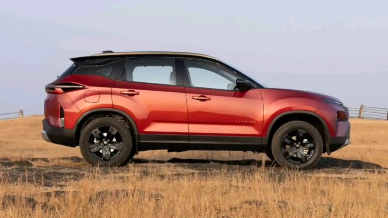Tata harrier Red SUV parked on dry grassland