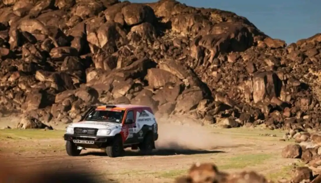 H3 category car navigating desert terrain